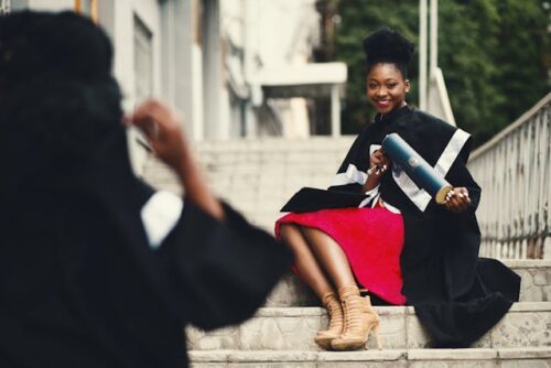 college graduate sitting on steps