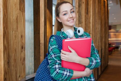 teenage girl holding notebook