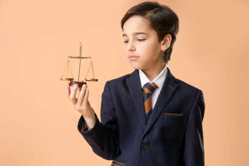 child with suit and scales of justice
